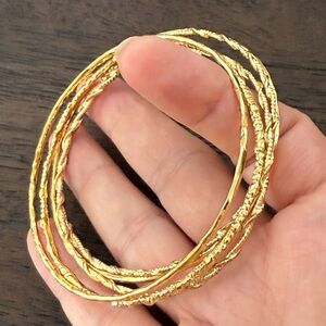 Bundle of 5 gold tone bangles bracelets